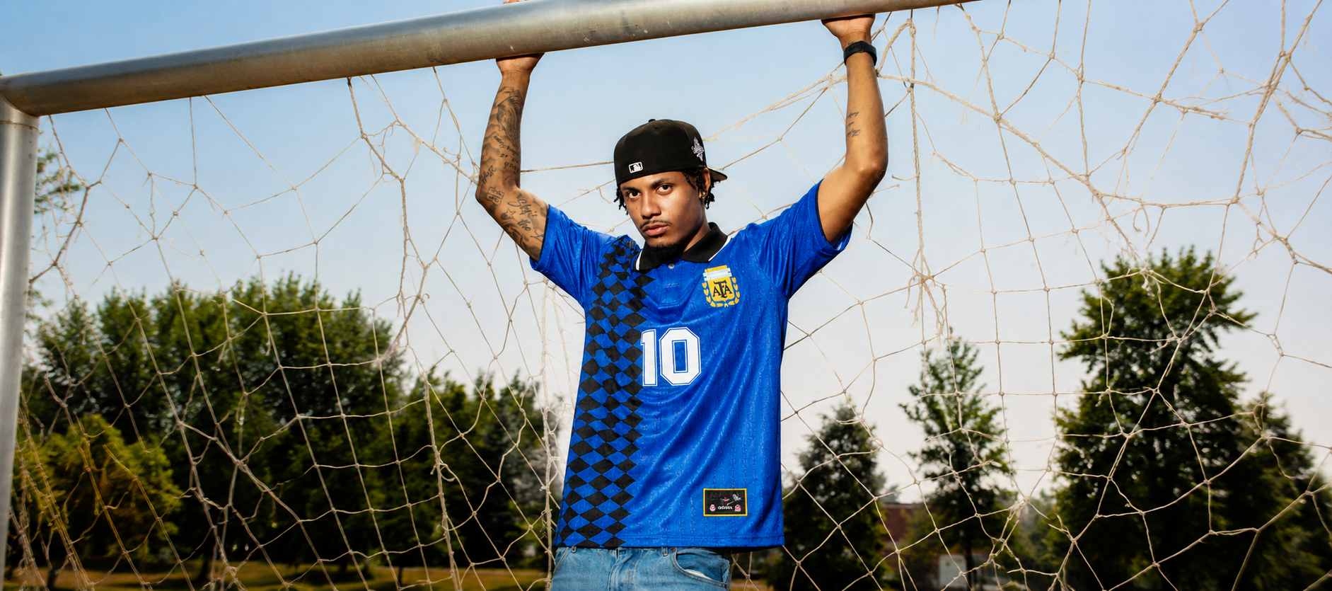 Model wearing a classic Argentina retro jersey on the pitch