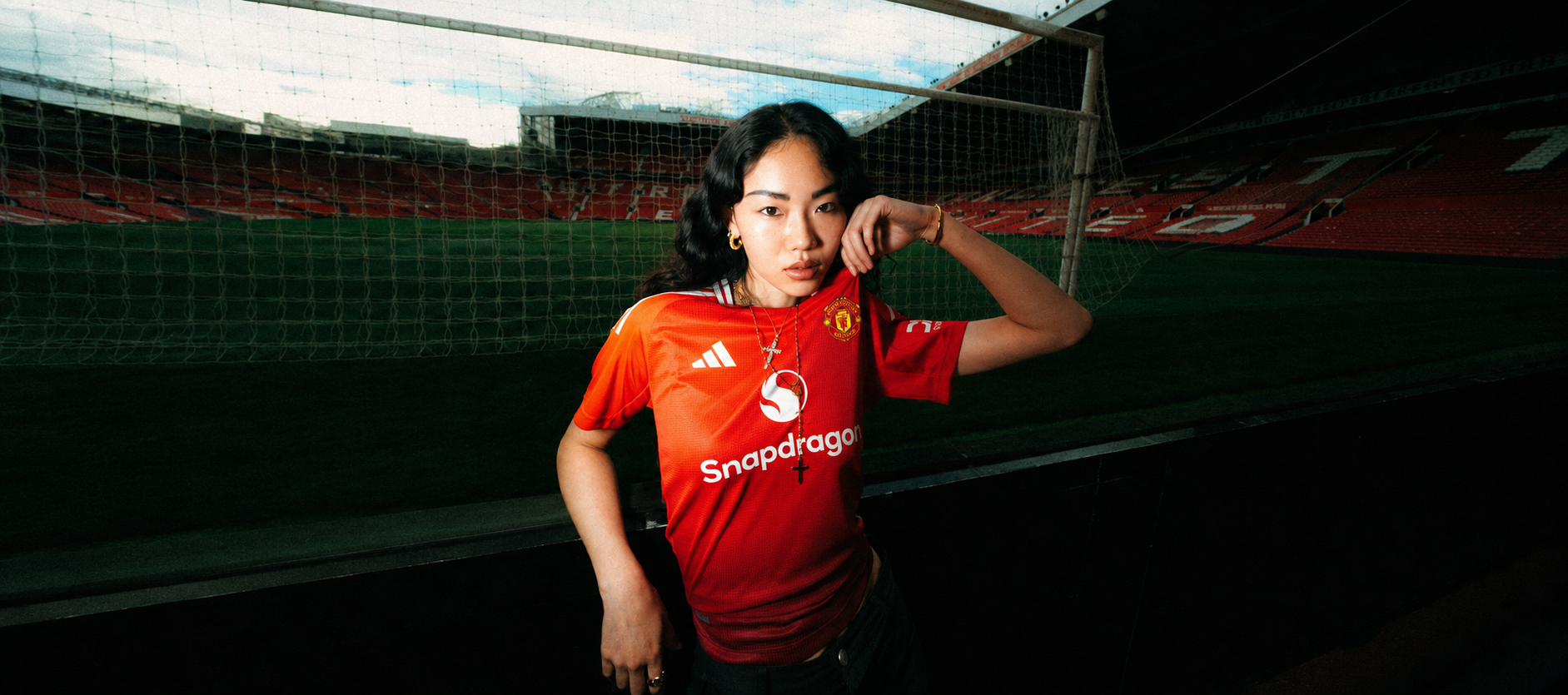 Model wearing a club jersey in a stadium